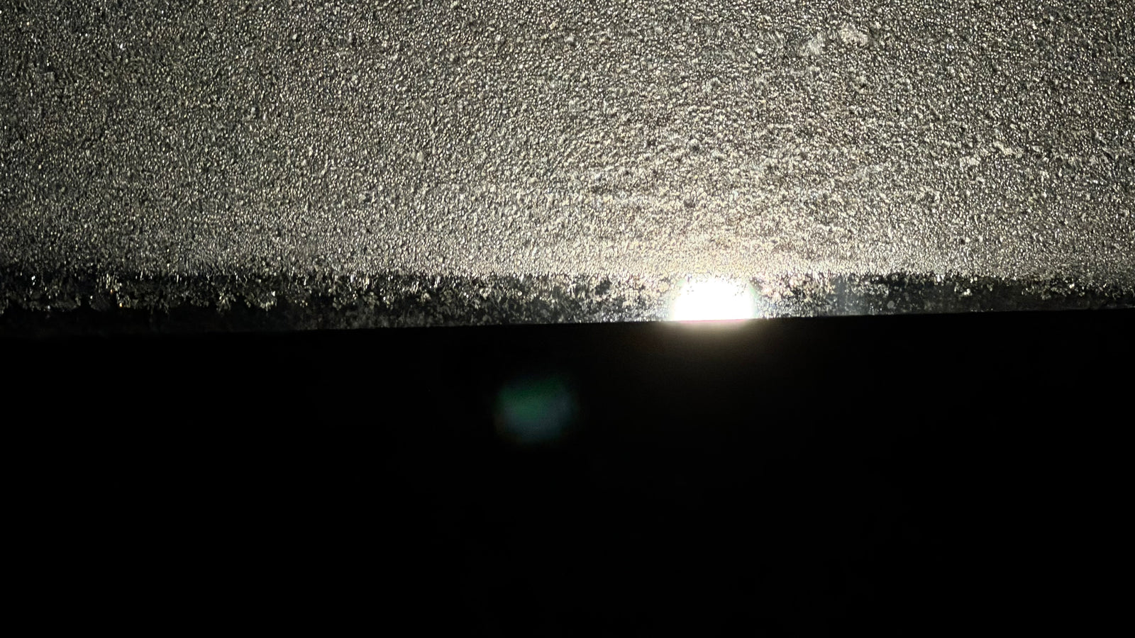 Close-up of a textured surface with a bright light source