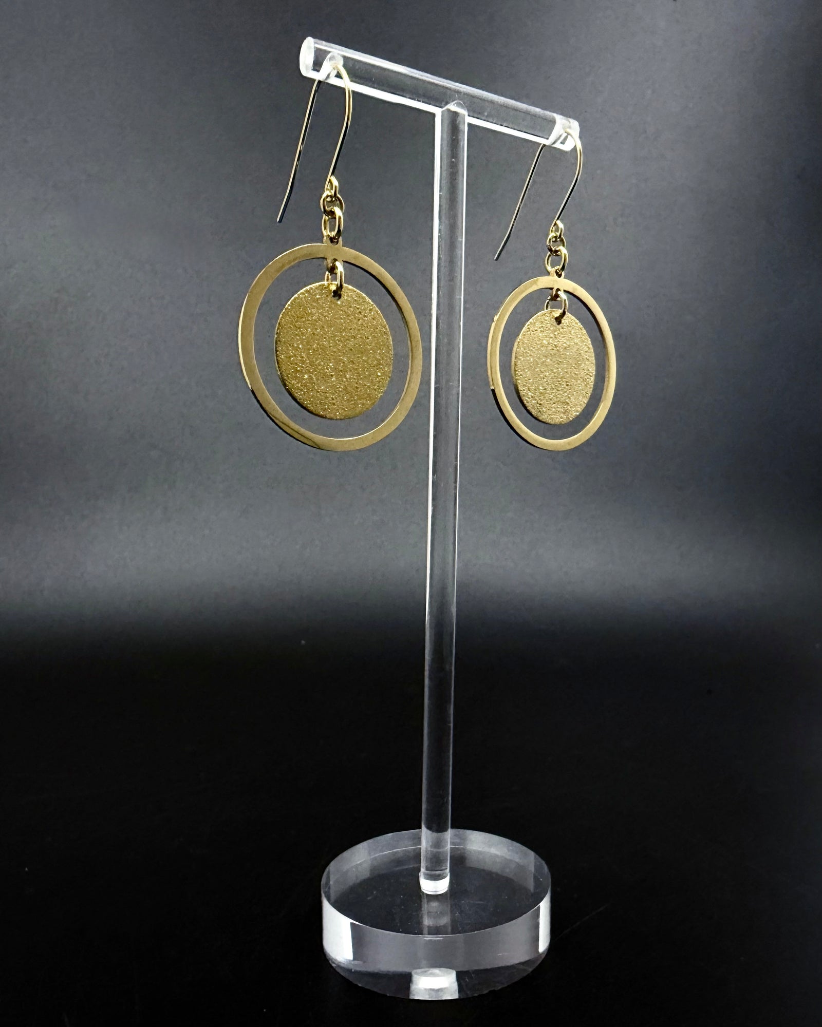 Large gold stainless steel halo earrings with a 30 mm polished ring and a suspended textured gold disc, high-shine finish — Lawless Jewellery