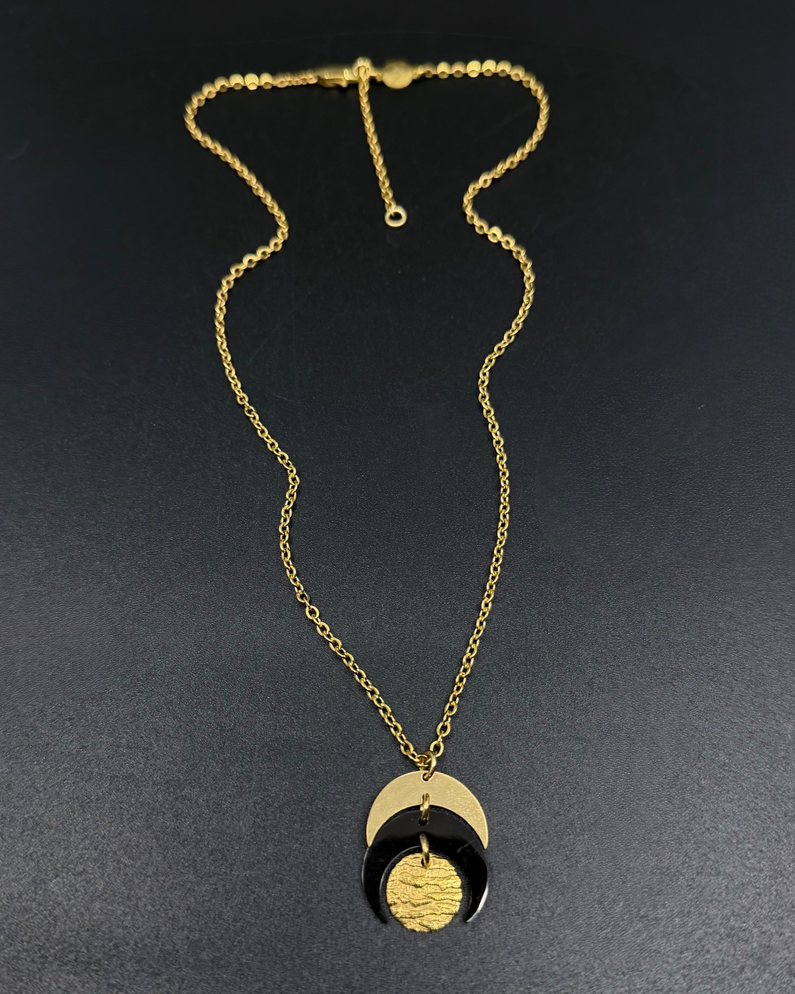 Gold and black stainless steel Luna Phase 20mm Necklace with sculptural crescent pendant and adjustable chain — Lawless Jewellery.