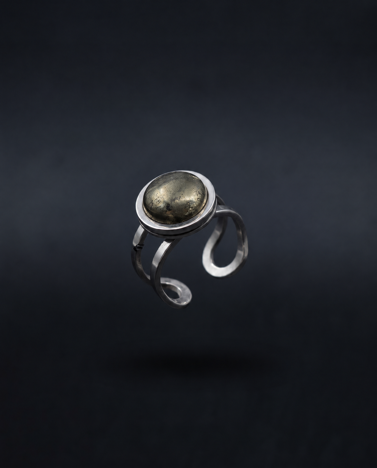 Nebulae Core adjustable silver ring with a 10mm domed natural pyrite cabochon in mottled graphite, bronze and antique-gold tones.