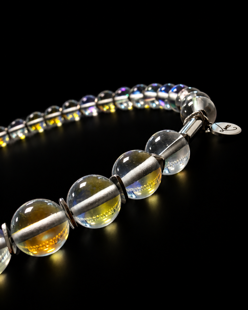 Nebulae Field Necklace featuring a strand of 10mm transparent iridescent glass beads with blue, violet and gold reflections, silver spacers, a stainless steel screw clasp and Lawless logo tag against a black background.