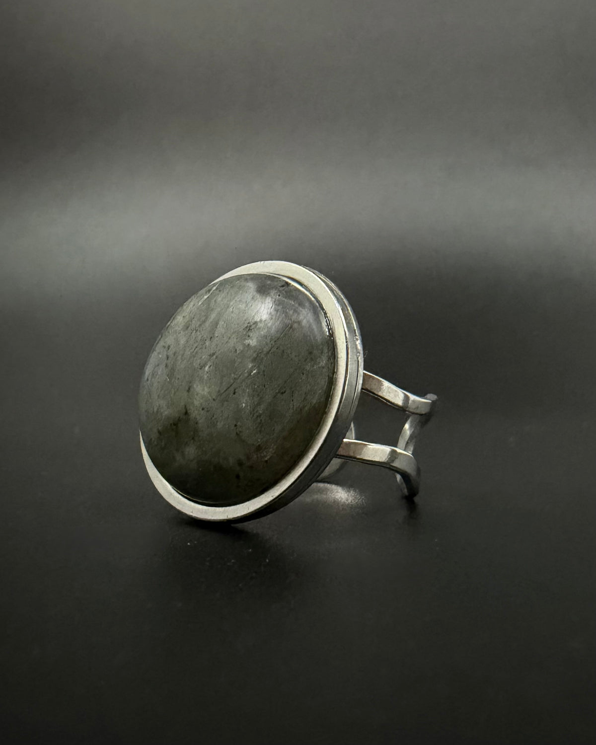 Silver adjustable double-shank ring with large 20 mm domed labradorite gemstone showing blue and grey flashes, Nebulae Core Ring by Lawless Jewellery.