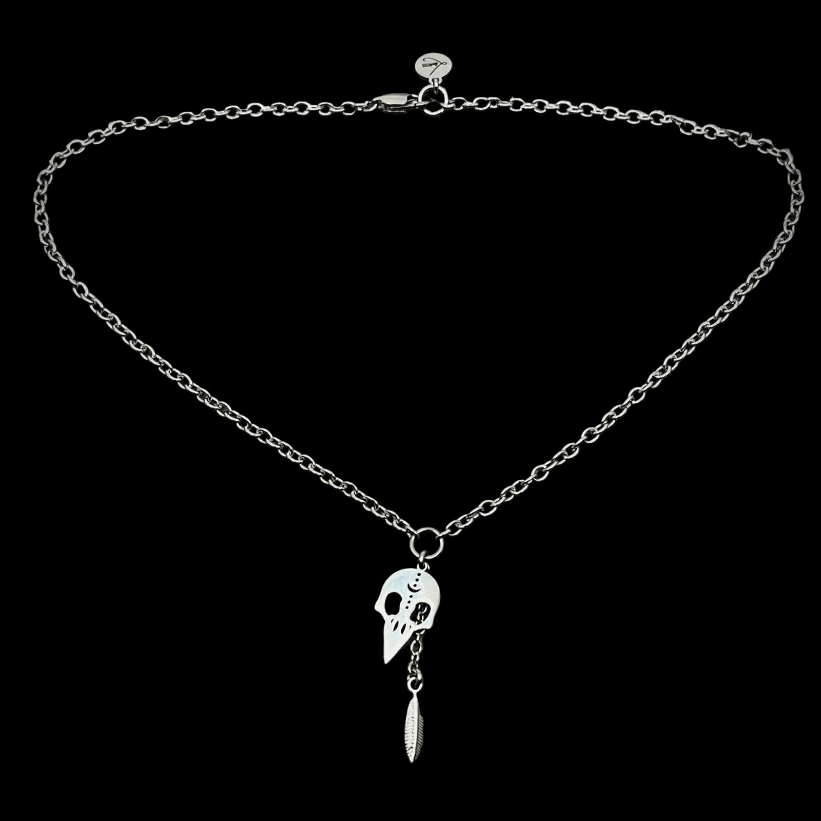 Silver necklace with pendant on a gray textured background
