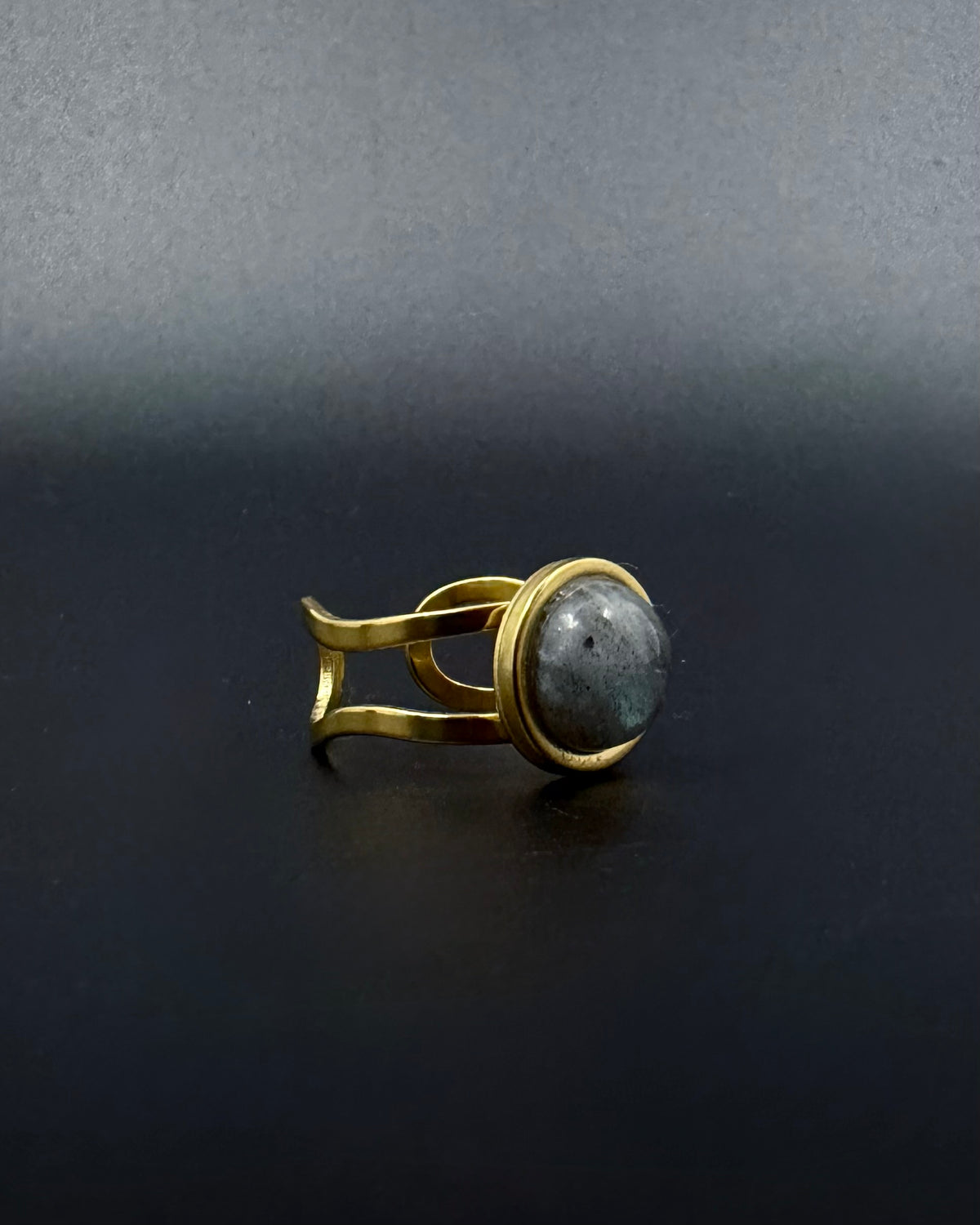Gold adjustable statement ring with 10mm domed labradorite gemstone showing blue-grey iridescence, double-shank stainless steel band, Nebulae Core Ring by Lawless Jewellery