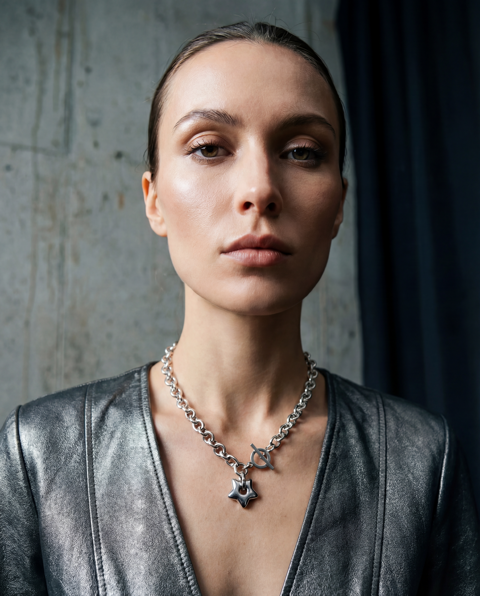 Silver stainless steel chain necklace with gold star pendant and toggle clasp, Urania Axis Necklace by Lawless Jewellery on black background