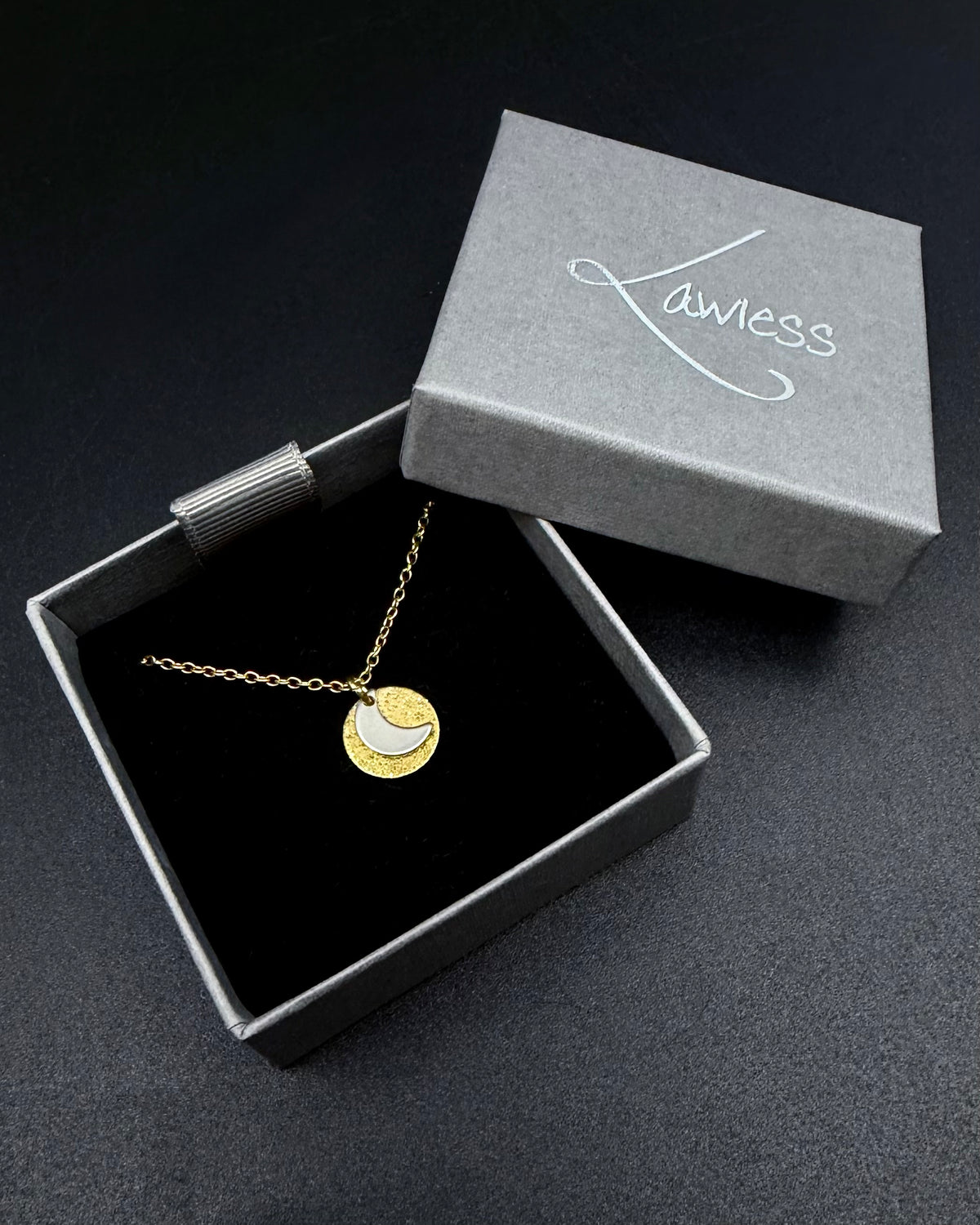 Mixed metal Urania Signal necklace with gold textured disc and silver crescent moon pendant on adjustable gold stainless steel chain