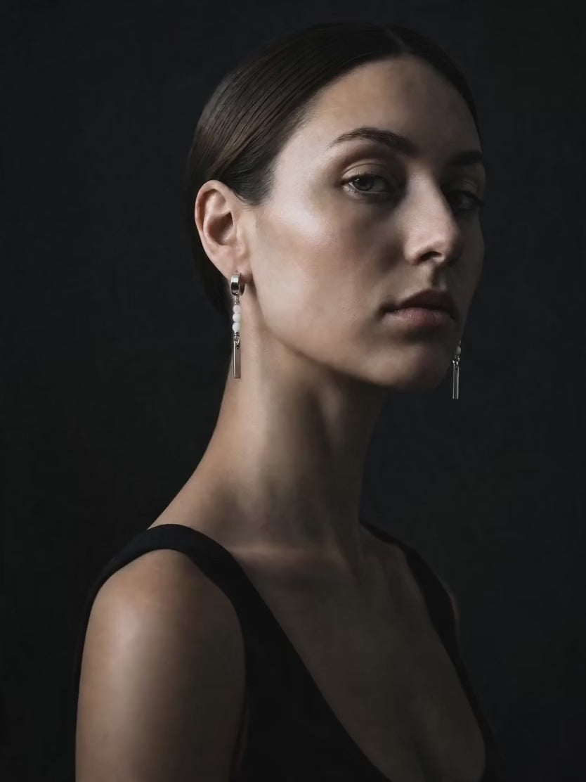Model wearing a pair of white bead hoop earrings from Lawless Jewellery