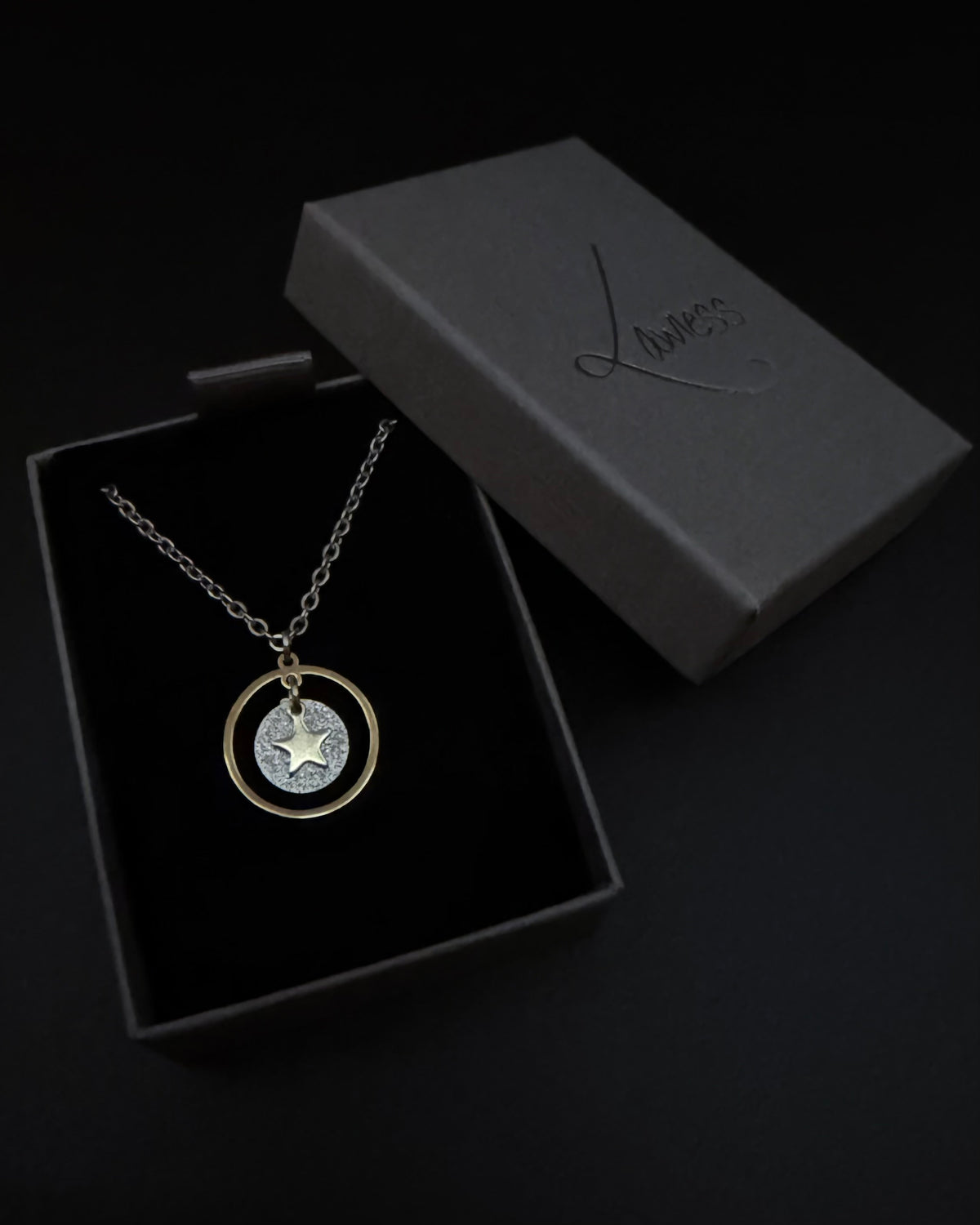 Reversible silver and gold necklace with detachable moon and star charms, mixed metal celestial pendant on chain, Urania Shapeshifter Necklace by Lawless Jewellery.